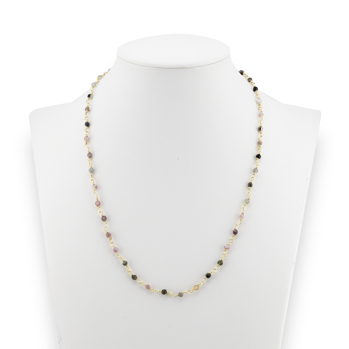 Necklace with multicolored beads on a mannequin bust against a white background