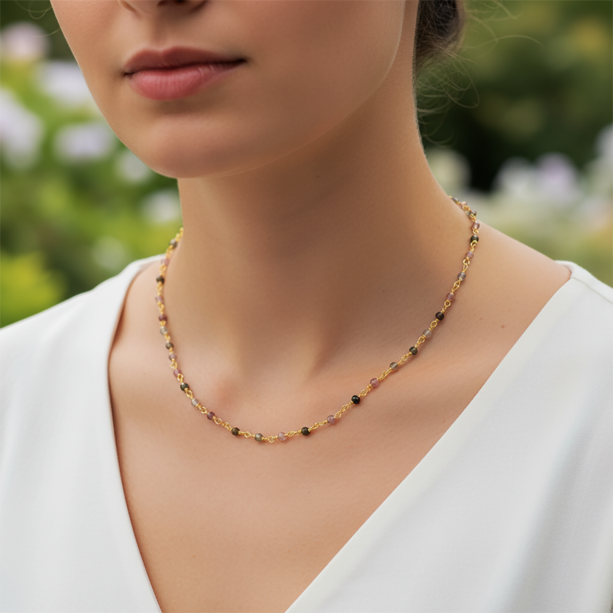 Necklace worn by a person with a blurred natural background