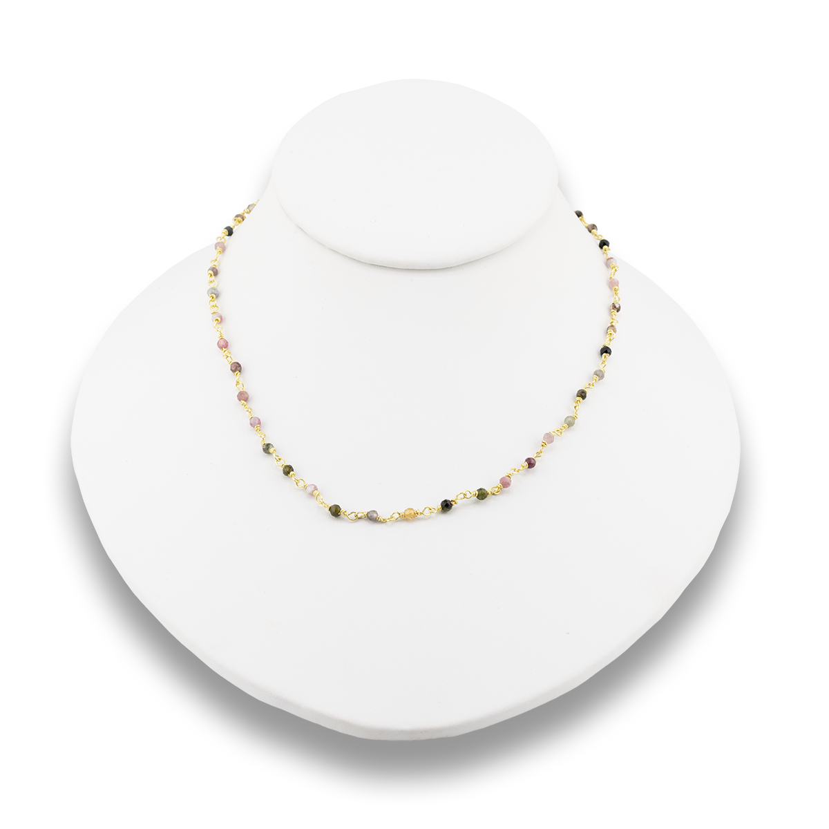 Necklace on a white stand with a white background