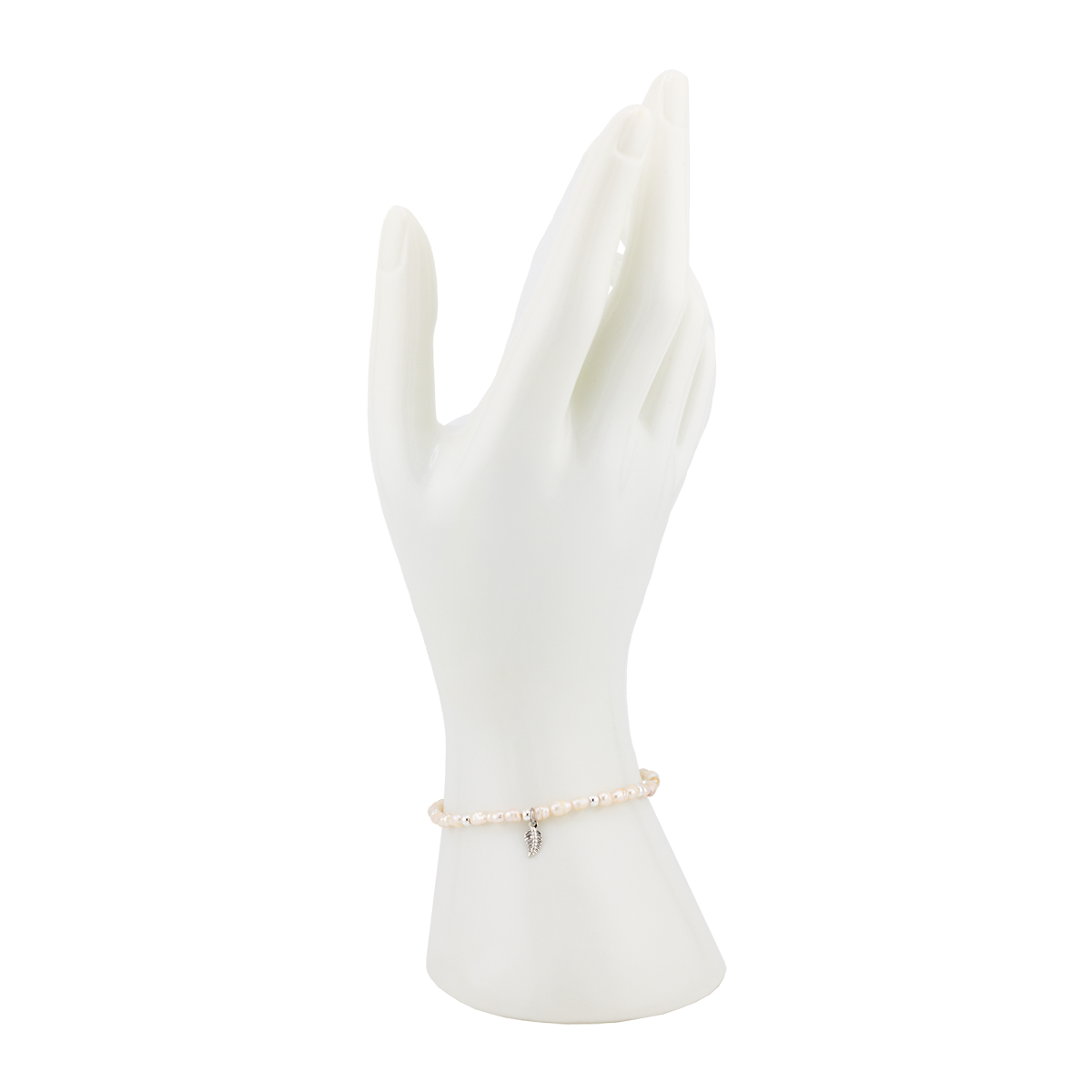 Pearl bracelet on a white mannequin hand with a white background