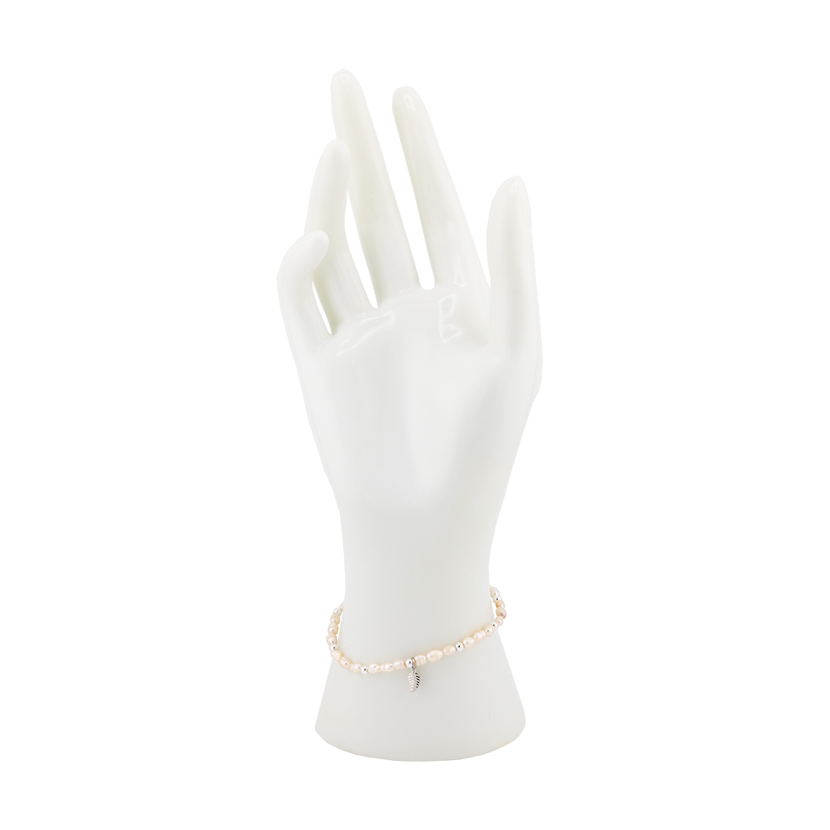 Mannequin hand wearing a pearl bracelet on a white background