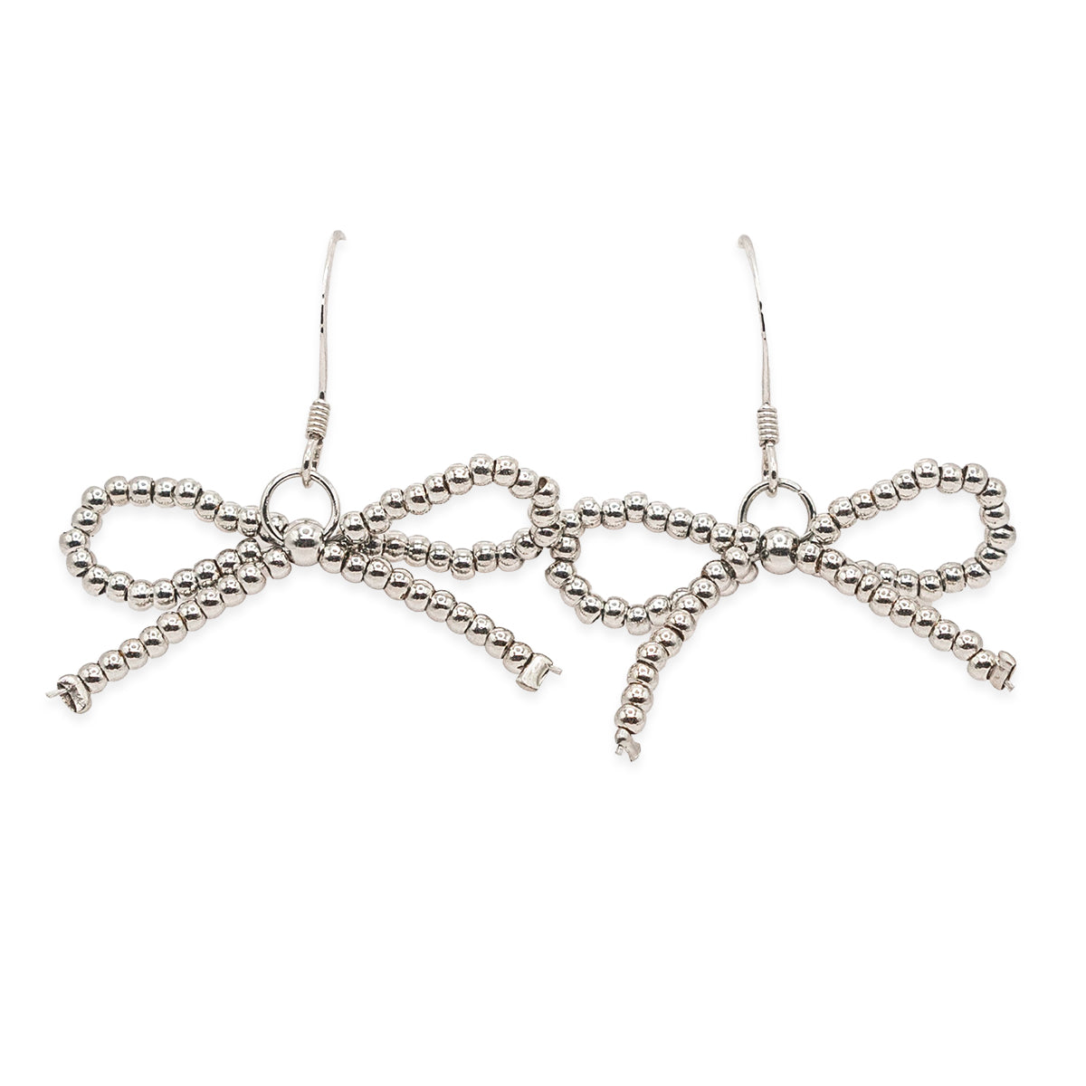 Silver bow-shaped earrings on a white background