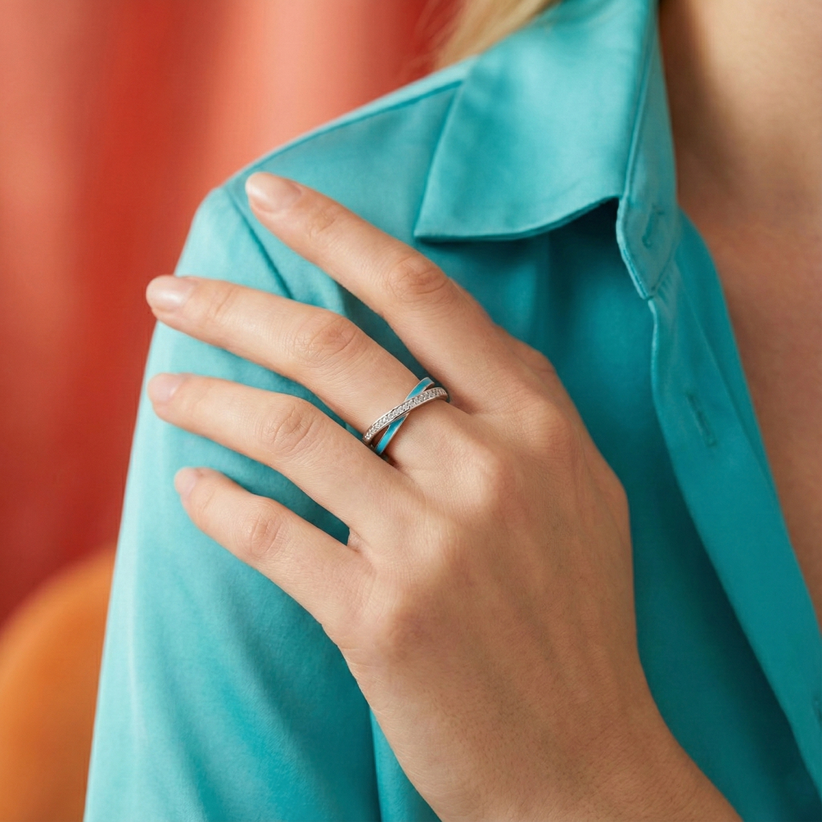 Close-up of a hand wearing a ring with a blurred background