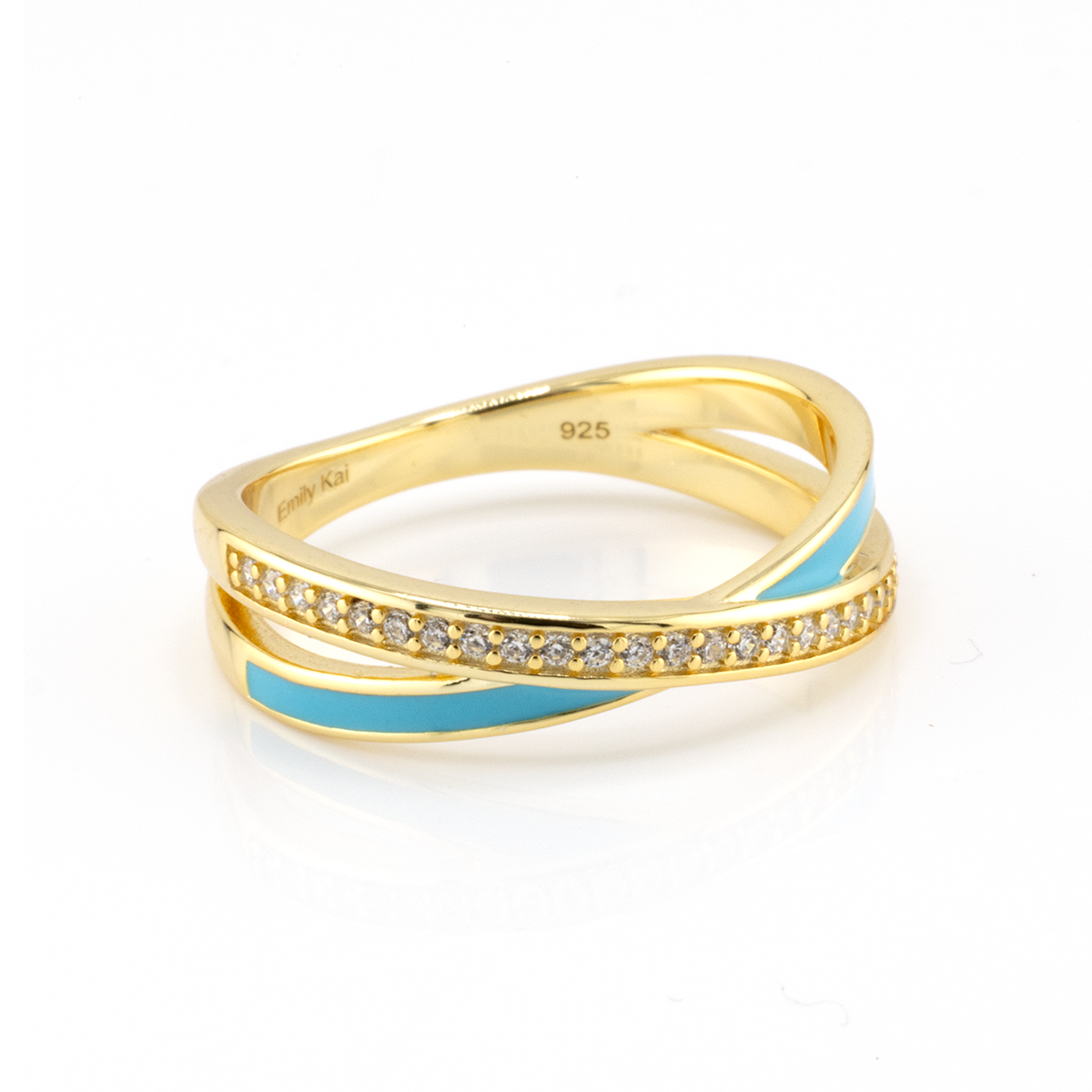 Gold ring with blue accents and diamond-like stones on a white background