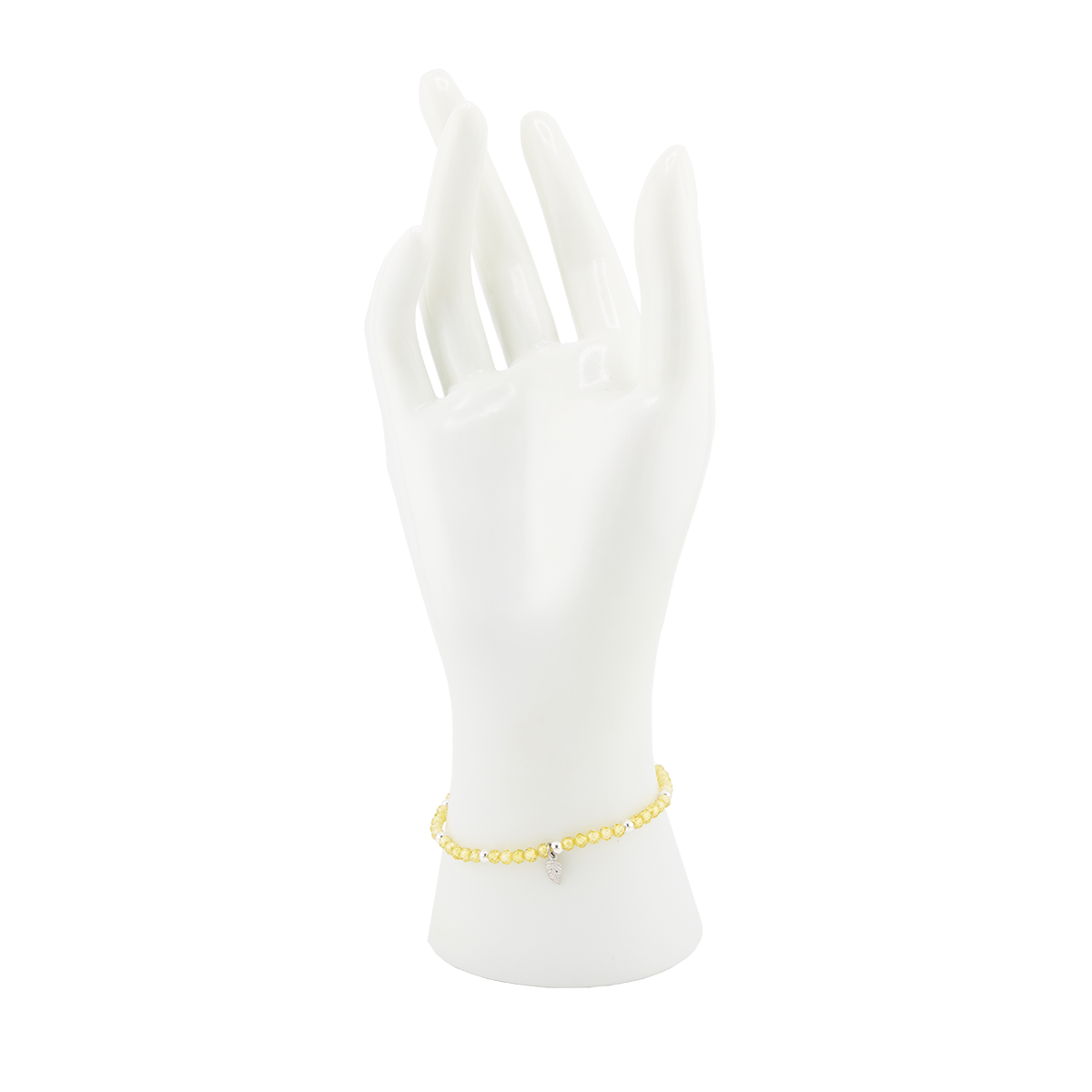 Gold bracelet on a white mannequin wrist against a white background