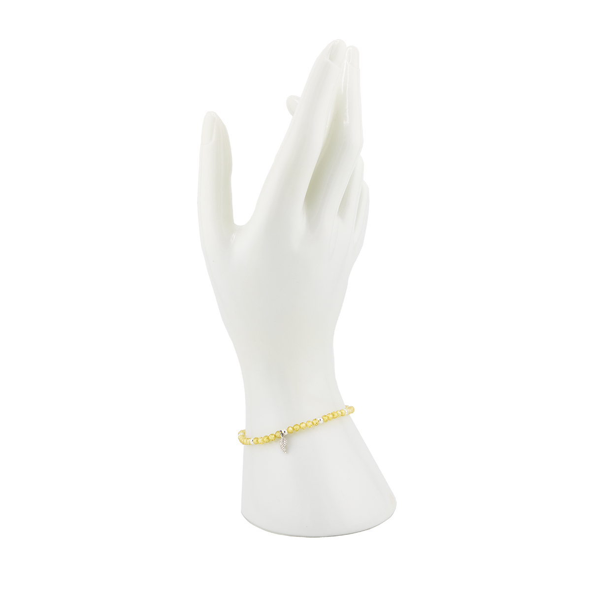 Gold bracelet on a white mannequin hand against a white background