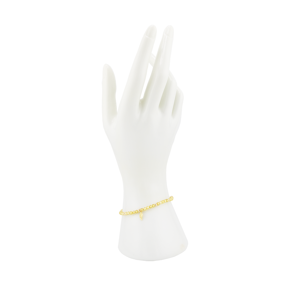Gold bracelet on a white mannequin hand against a white background