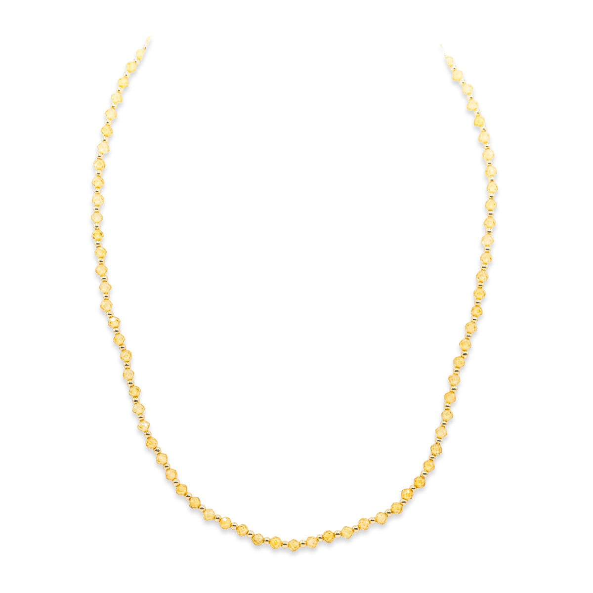 Gold beaded necklace on a white background