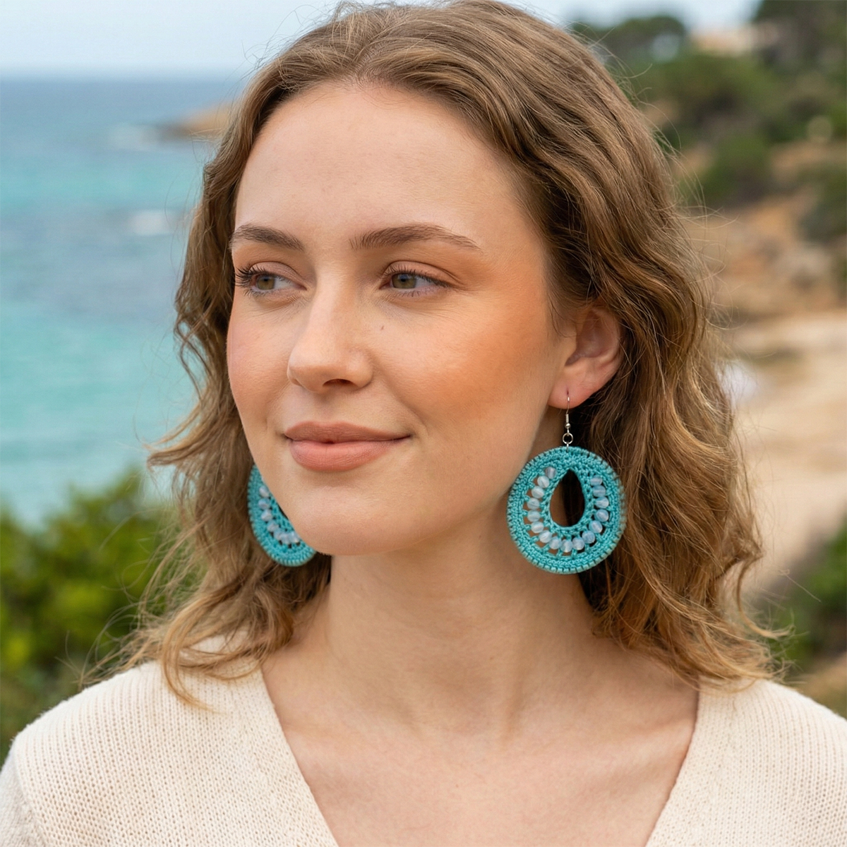 Woman wearing turquoise earrings with a scenic background