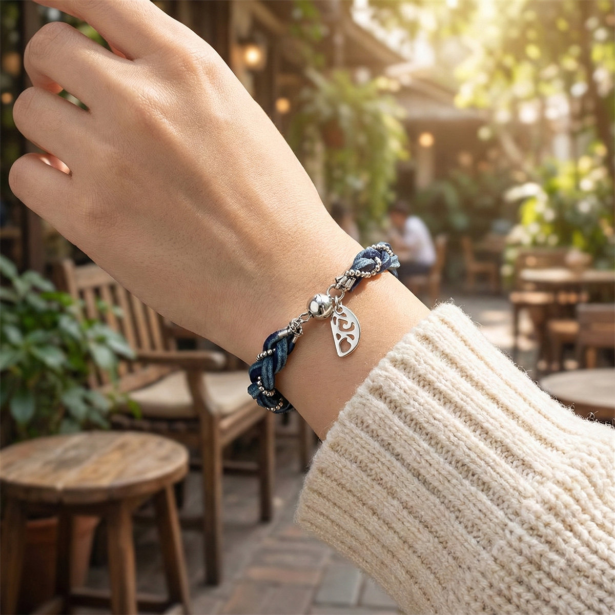 Hand wearing a bracelet with outdoor setting