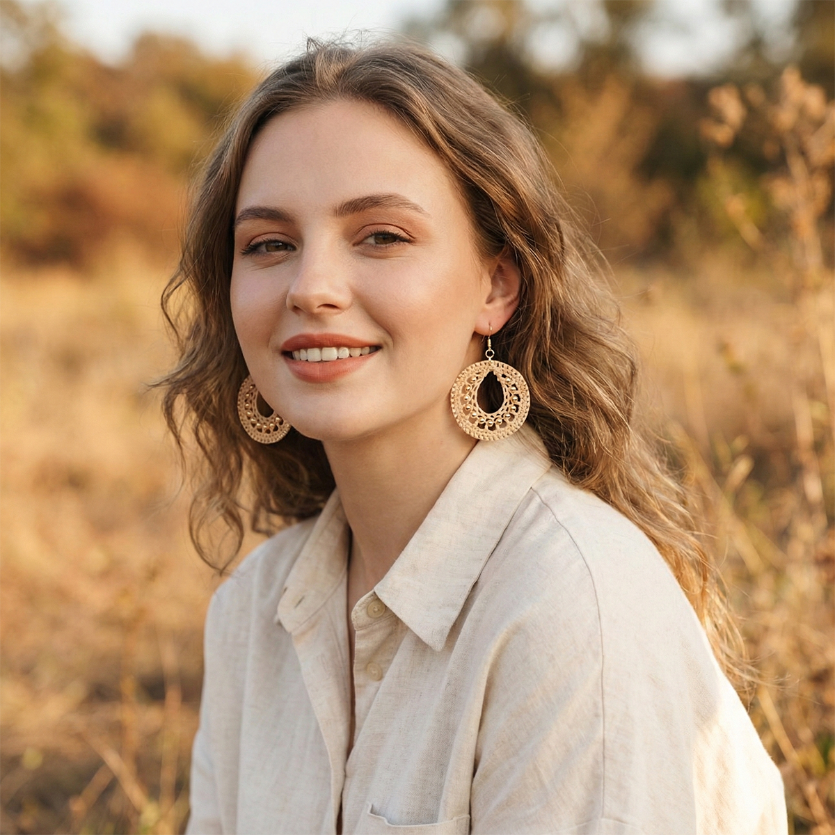 Woman wearing gold hoop earrings in a natural setting